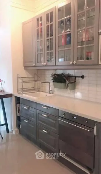 Modern kitchen with sleek cabinetry and built-in oven