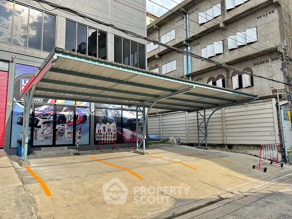 Spacious covered parking area in urban setting with modern design and ample space.