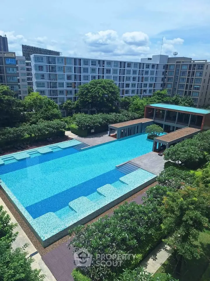 Luxurious residential complex with stunning pool and lush greenery