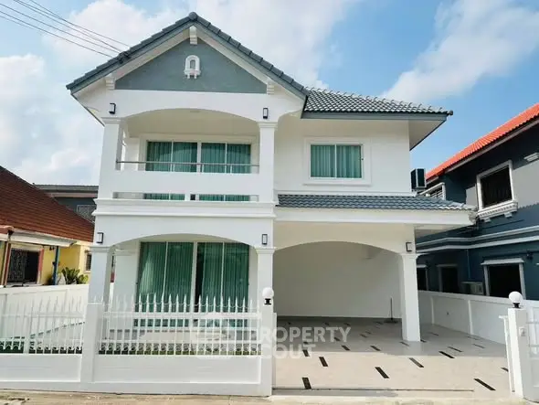 Charming two-story house with modern design and spacious driveway in a serene neighborhood.