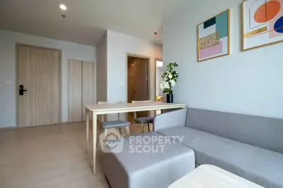 Modern living room with stylish decor and cozy seating in a contemporary apartment.