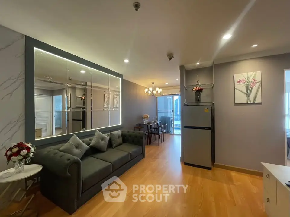 Modern living room with elegant decor and spacious layout, featuring a stylish sofa and dining area.