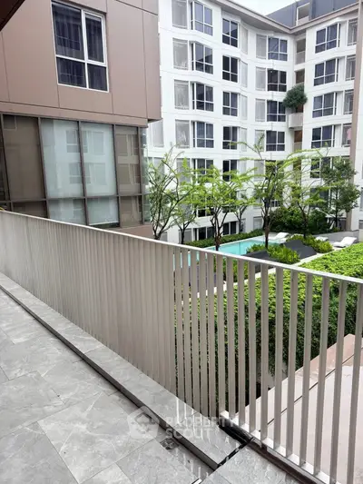 Modern apartment building with lush garden view from balcony