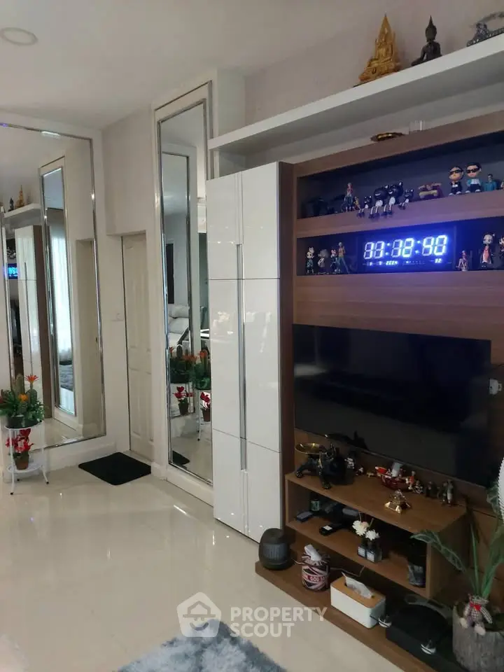 Modern living room with sleek entertainment center and mirrored decor