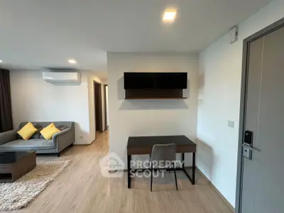 Modern living room with stylish furniture and study area, featuring sleek design and cozy ambiance.