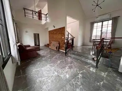 Spacious modern living room with high ceilings and elegant marble flooring