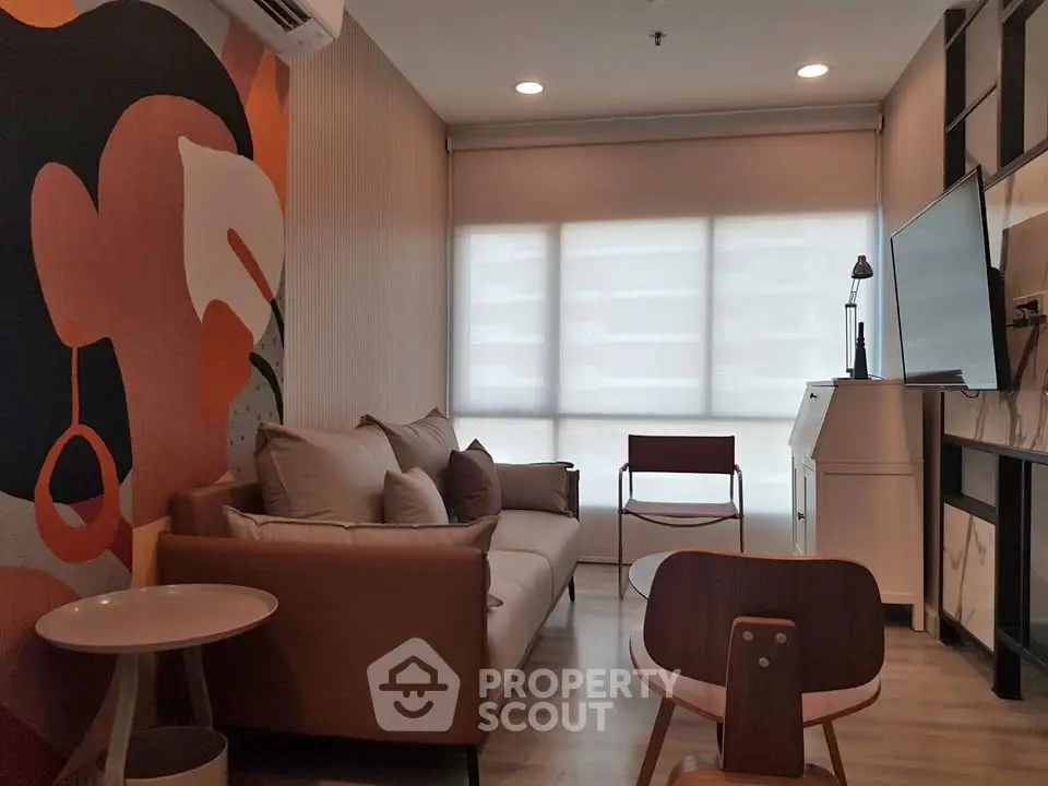 Stylish modern living room with artistic wall mural and cozy seating area.