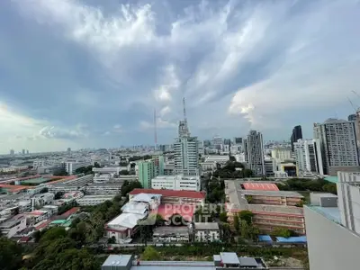 Stunning cityscape view from a high-rise building showcasing urban skyline and expansive sky.