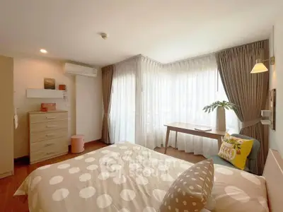 Bright and cozy bedroom with large windows and stylish decor