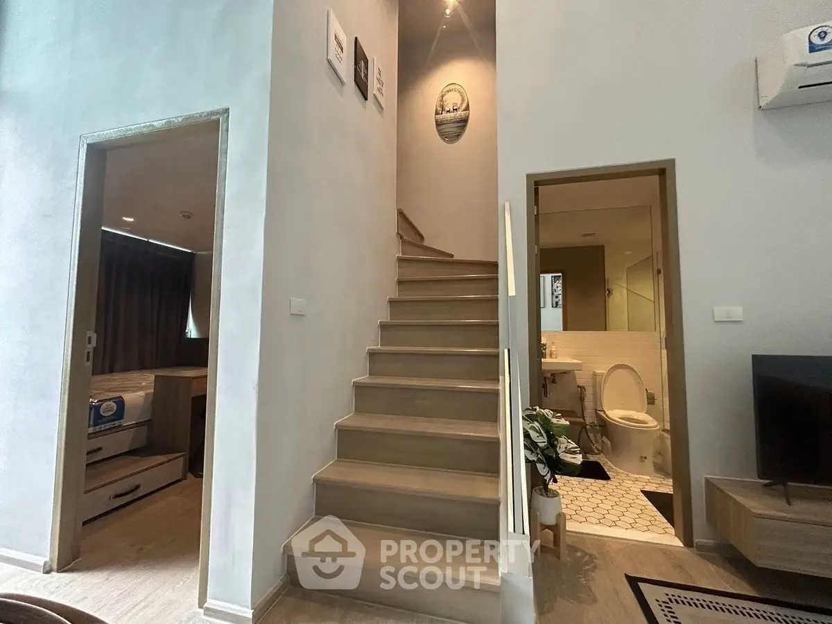 Modern duplex interior with staircase, bedroom, and bathroom view