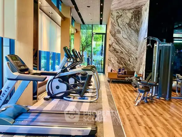 Luxurious gym with modern equipment and scenic view in upscale property.