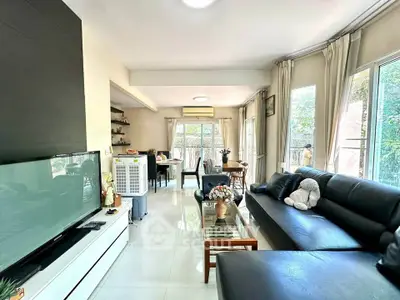 Spacious living room with modern decor and large windows for natural light.