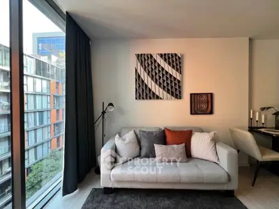 Modern living room with stylish decor and large window offering city view