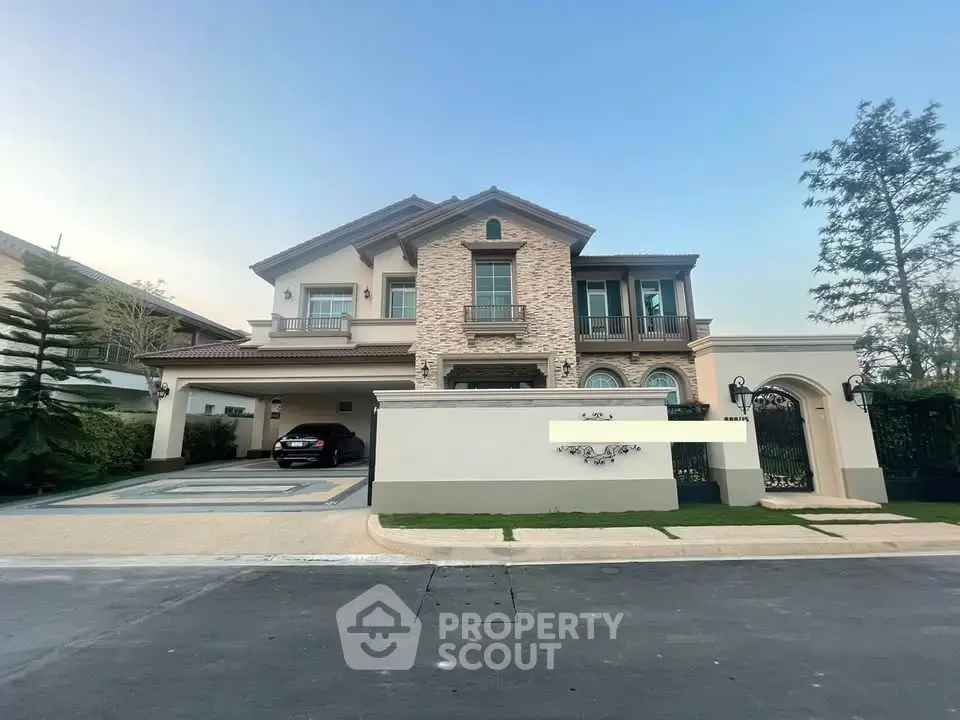 Luxurious two-story house with elegant facade and spacious driveway in upscale neighborhood.