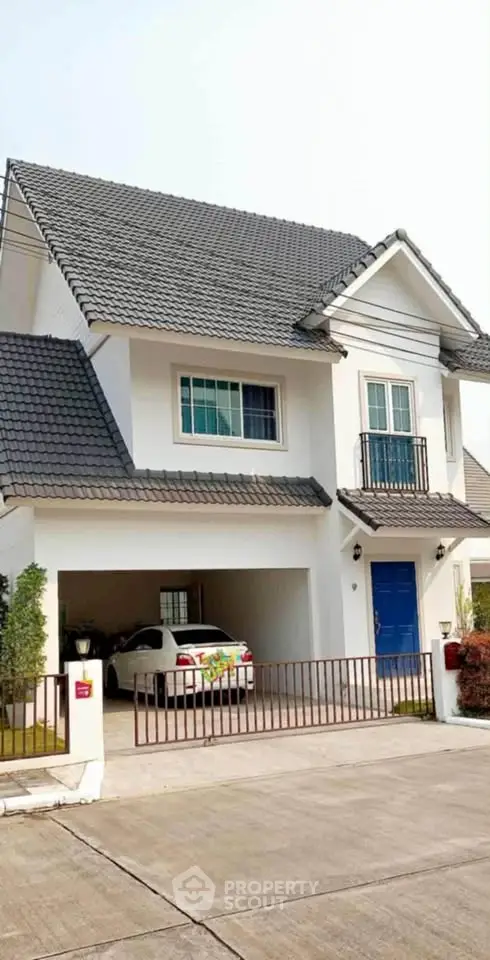 Charming two-story house with garage and balcony in a serene neighborhood.