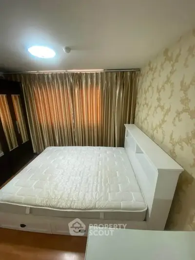 Cozy bedroom with elegant wallpaper and ample natural light