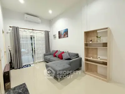Modern living room with sleek furniture and natural light, perfect for relaxation and entertaining.