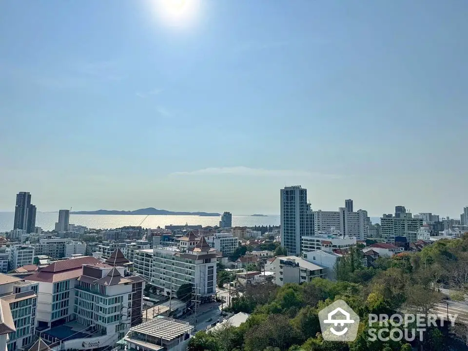 Stunning cityscape view with ocean horizon from high-rise apartment balcony.