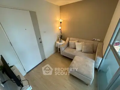 Cozy living room with modern sofa and ambient lighting in a stylish apartment.
