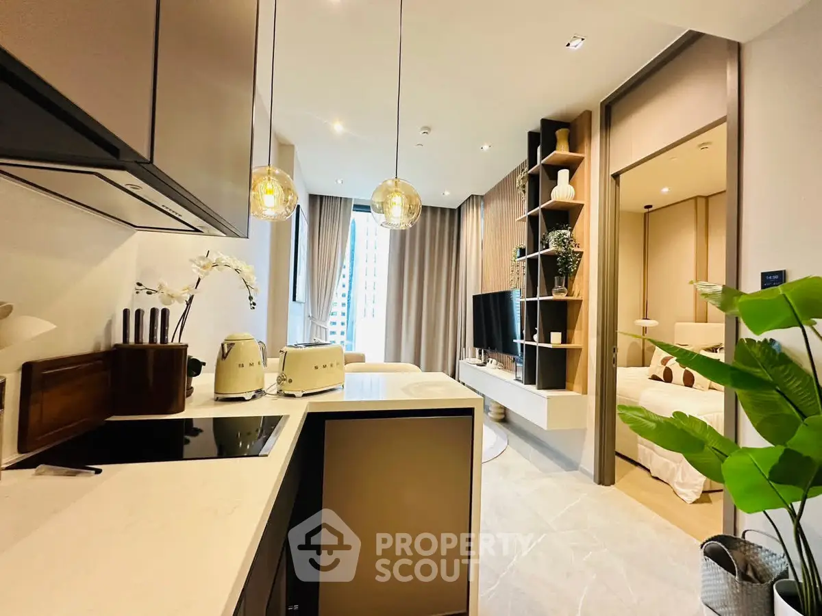 Modern open-plan kitchen and living room with elegant decor and natural light.