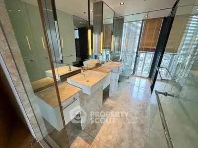 Luxurious modern bathroom with dual sinks and floor-to-ceiling windows