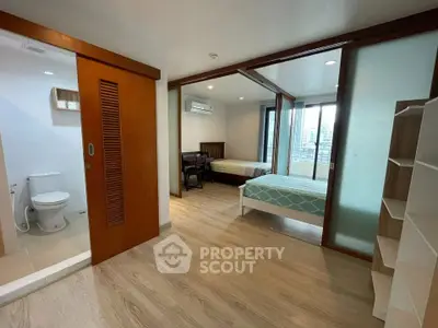 Spacious modern bedroom with ensuite bathroom and balcony view