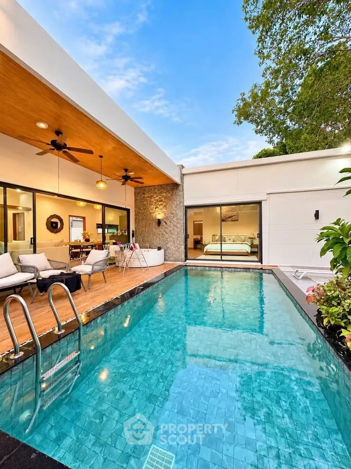 Luxurious modern villa with private pool and stylish outdoor seating area, perfect for relaxation.