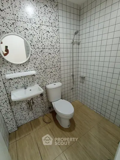 Modern bathroom with stylish tiles and compact fixtures