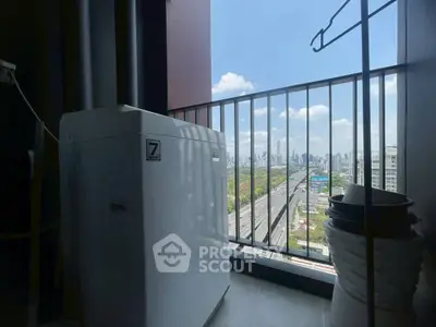 High-rise balcony with city skyline view and washing machine, perfect urban living.