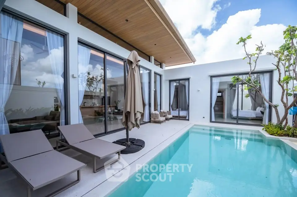 Luxurious modern villa with private pool and elegant outdoor seating area, perfect for relaxation and entertainment.