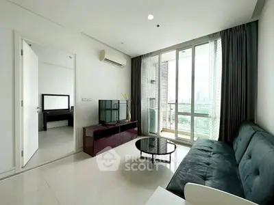 Modern living room with sleek furniture and city view balcony