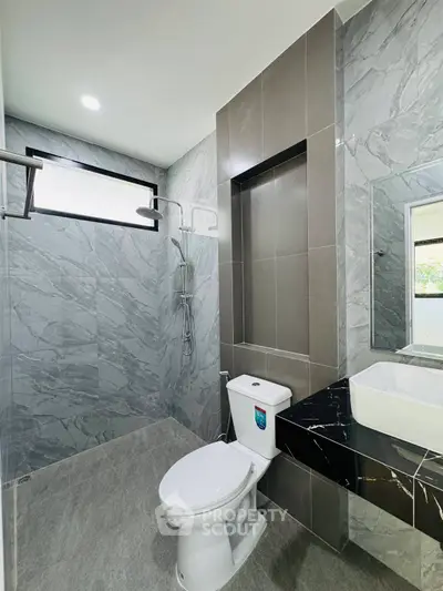 Modern bathroom with sleek marble tiles and contemporary fixtures