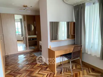 Spacious bedroom with elegant parquet flooring and stylish wooden furniture.