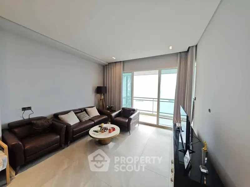 Spacious modern living room with balcony and elegant decor