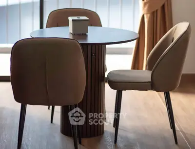 Stylish dining area with modern round table and elegant chairs, perfect for cozy meals.