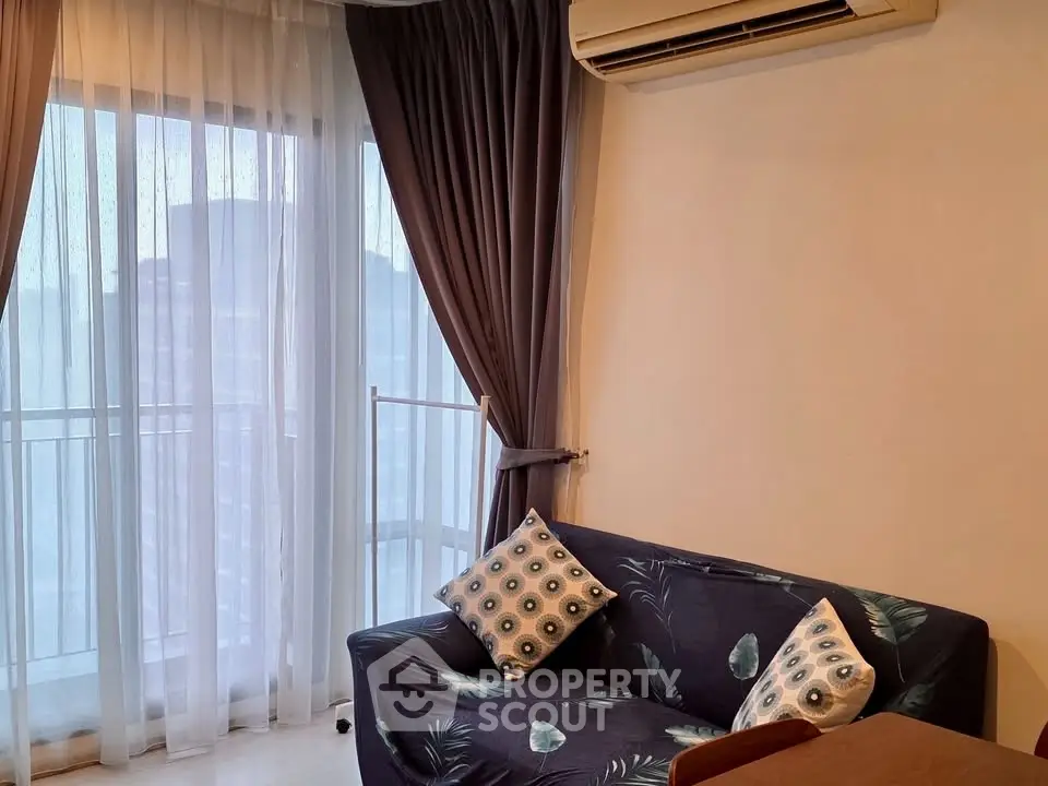 Cozy living room with stylish sofa and large window view