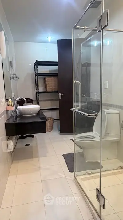 Modern bathroom with glass shower and sleek fixtures in a contemporary home.