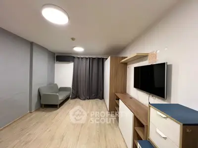 Modern living room with sleek furniture and wall-mounted TV