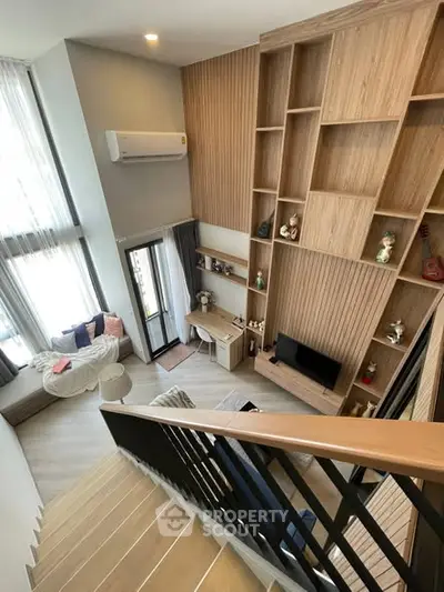 Modern duplex living room with high ceilings and stylish wooden shelving