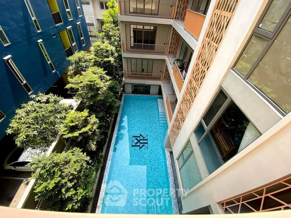 Stunning apartment view with a luxurious pool and modern architecture.