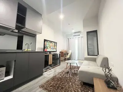 Modern living room with sleek kitchen and cozy seating area in stylish apartment.