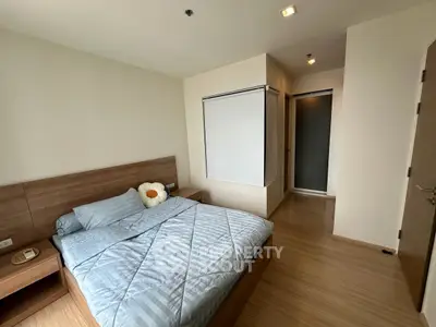 Modern bedroom with wooden flooring and cozy decor