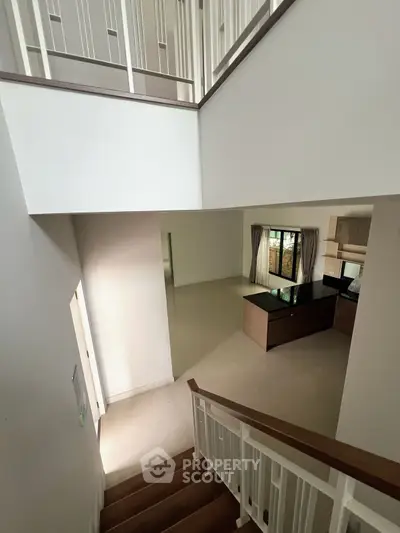 Spacious modern interior with open kitchen and elegant staircase