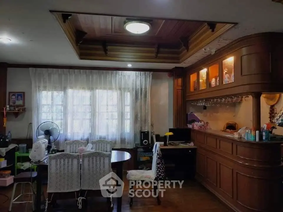 Charming living room with wooden ceiling and built-in bar area, perfect for entertaining guests.