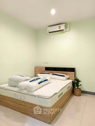 Cozy bedroom with modern air conditioning and stylish decor
