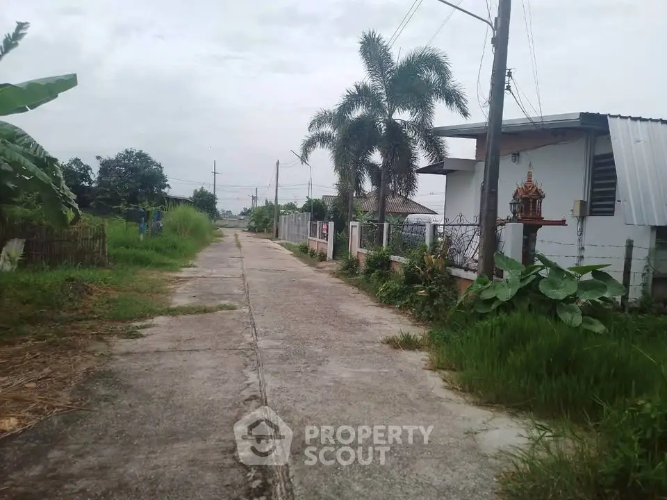 Charming rural property with lush greenery and a serene pathway, perfect for tranquil living.