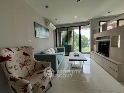 Spacious living room with modern furniture and large windows offering a scenic view.