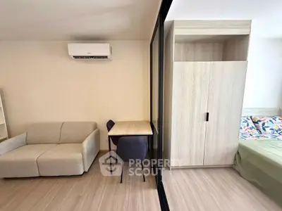 Modern studio apartment with cozy living area and stylish furniture