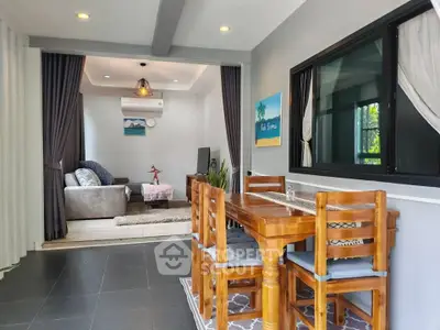 Charming open-plan living and dining area with cozy decor and natural light.