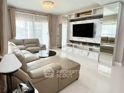 Luxurious living room with elegant marble TV wall and plush leather seating